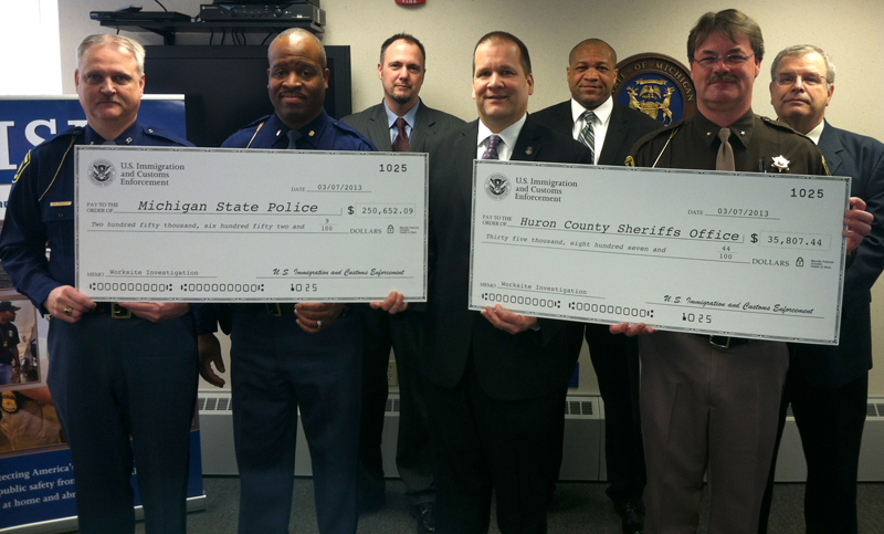 HSI presents checks to local and state officials for their assistance in a worksite investigation.
