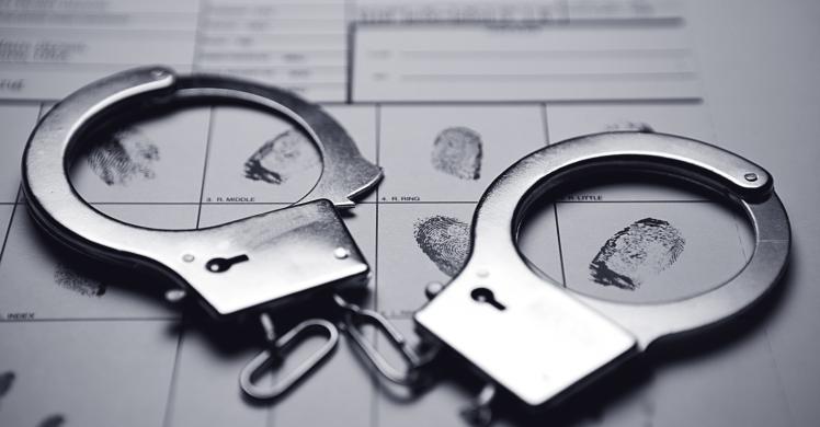  image of handcuffs on a fingerprint sheet