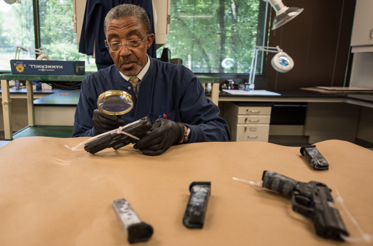 HSI Forensic Laboratory: Agent inspecting evidence