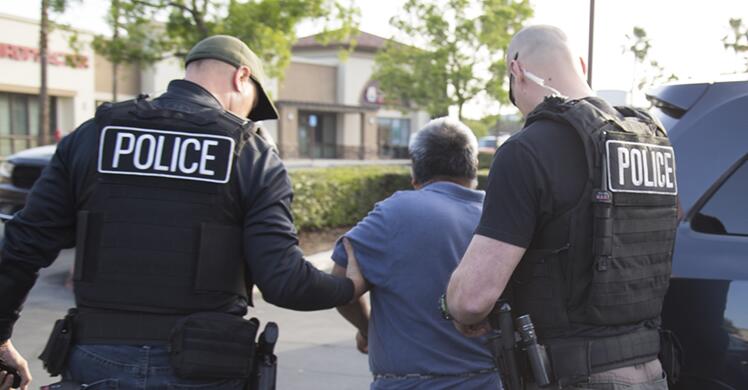 an individual being escorted by officers