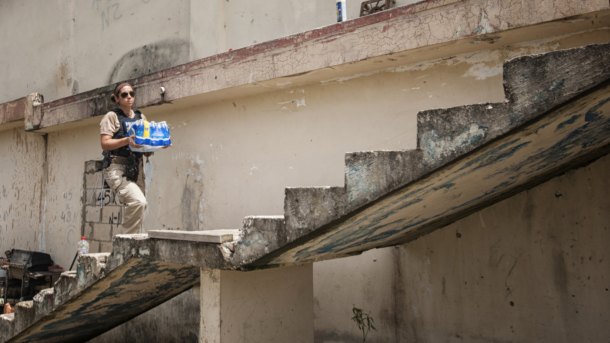 Special Agent Megan Shields of the HSI New York City Rapid Response Team delivers water in Barrio Campanella, Toa Baja, Puerto Rico.