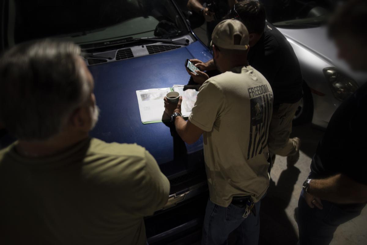 ICE officers assigned to an Enforcement and Removal Operations (ERO) Fugitive Operations team in Fort Myers, FL conduct a pre-dawn mission brief prior to conducting a targeted enforcement operation in search of a confirmed MS-13 gang member. During the operation the ERO officers were joined by special agents from Homeland Security Investigations (HSI) as well as agents and officers from Customs and Border Protection (CBP) and the United States Marshalls.