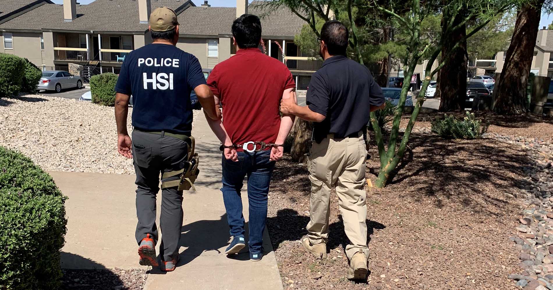 Homeland Security Investigations (HSI) El Paso special agents escort Kevin Holguin-Cano out of his residence after taking him into custody in June 2021.