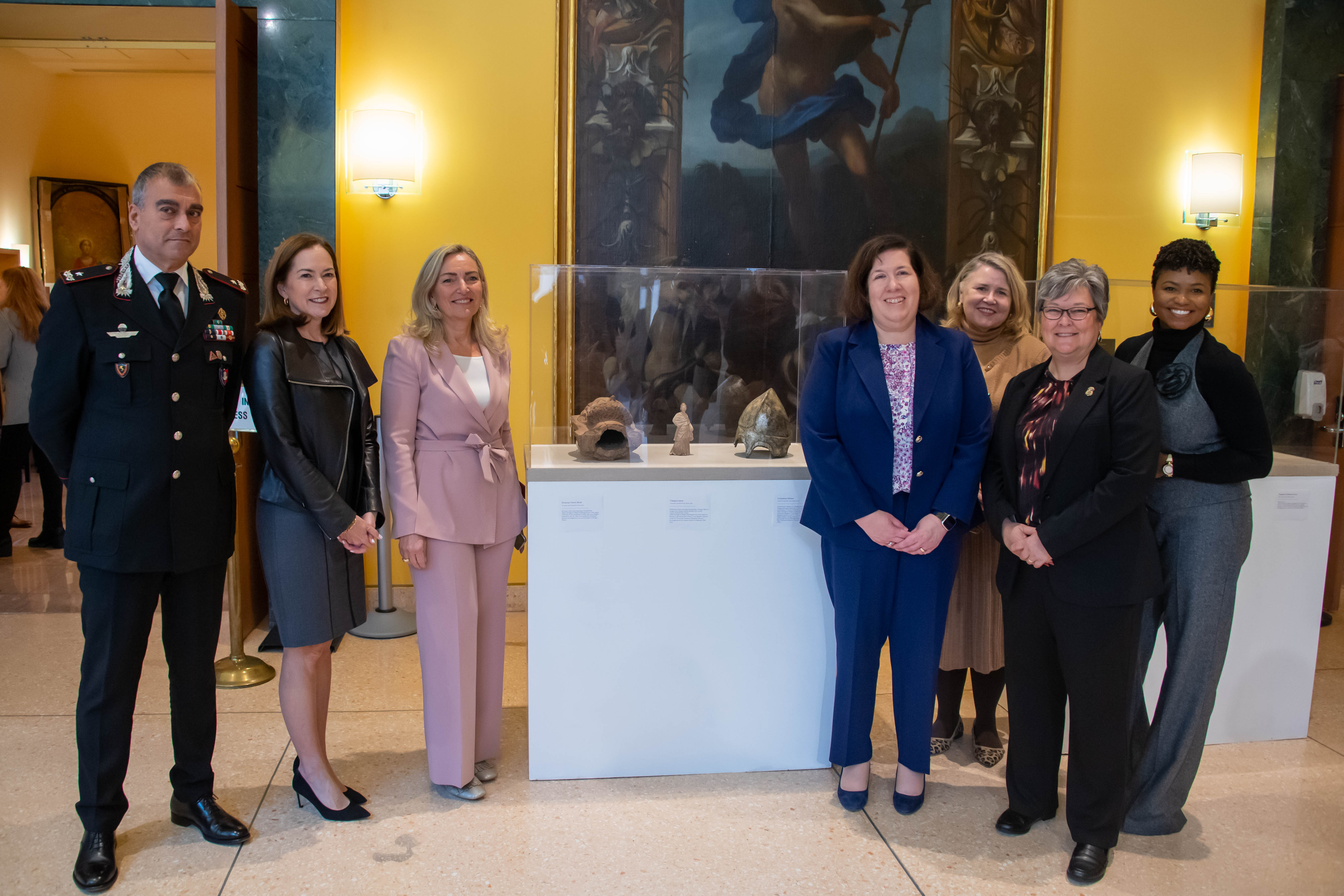 From left: Francesco Gargaro of the Carbinieri, Lee Satterfield of the U.S. State Department, Italian Ambassador to the United States Mariangela Zappia, ICE Senior Official Performing the Duties of the Deputy Director Staci Barerra, Senior Adviser Mary Cook of CPAA, HSI Executive Associate Director Katrina Berger, and Kenia Harris of CPAA standing in front of a fragment of a Roman fresco from the end of the first century BCE in Etruria, Italy. 