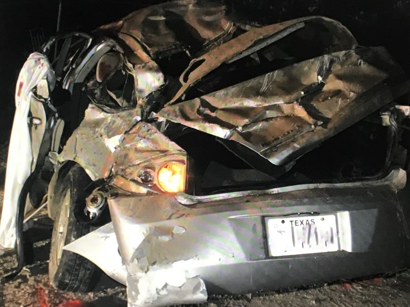 A crumpled car with a Texas license plate