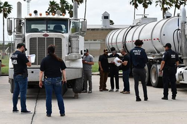 ICE HSI special agents checking paperwork pertaining to the oil tankers seized in the Rio Grande Valley.