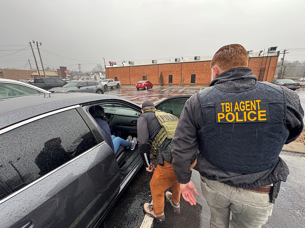 An ICE officer and an agent with the Tennessee Bureau of Investigations prepare to transport an illegal alien from Venezuelan with ties to the Tren da Aragua gang. She was arrested for her role in an illegal commercial sex and sex trafficking enterprise out of Nashville motels from July 2022 through March 2024.