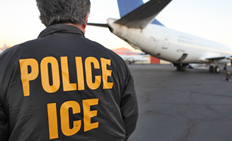 ICE Agent in front of a plane