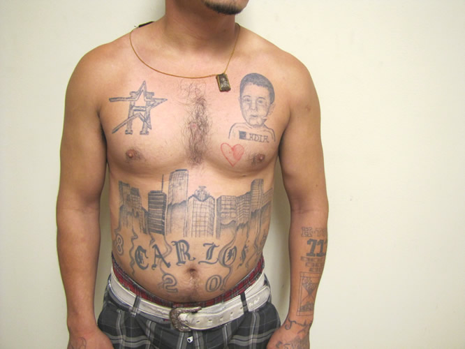gang member covered with tattoos