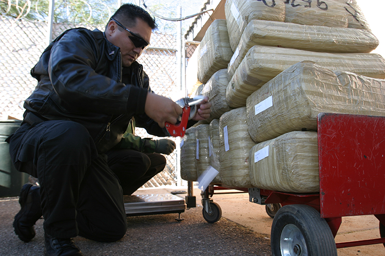 ITO Harold Myers inspects seized narcotics