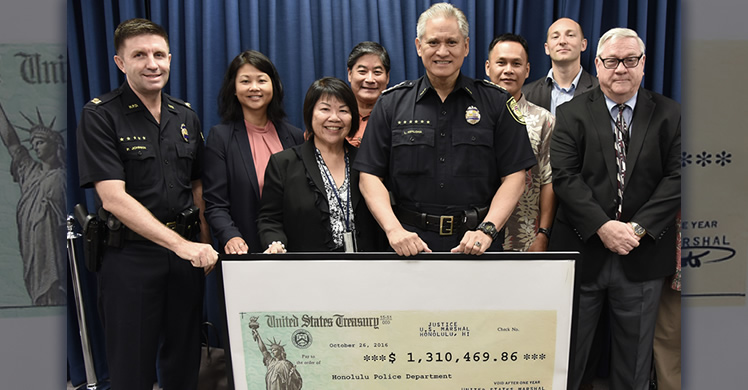 Hawaii U.S. Attorney Florence T. Nakakuni (front left) delivers check to Honolulu Police Chief Louis Kealoha joined by Honolulu SAC Joanna Ip (back row, second from left) and other federal agency representatives.
