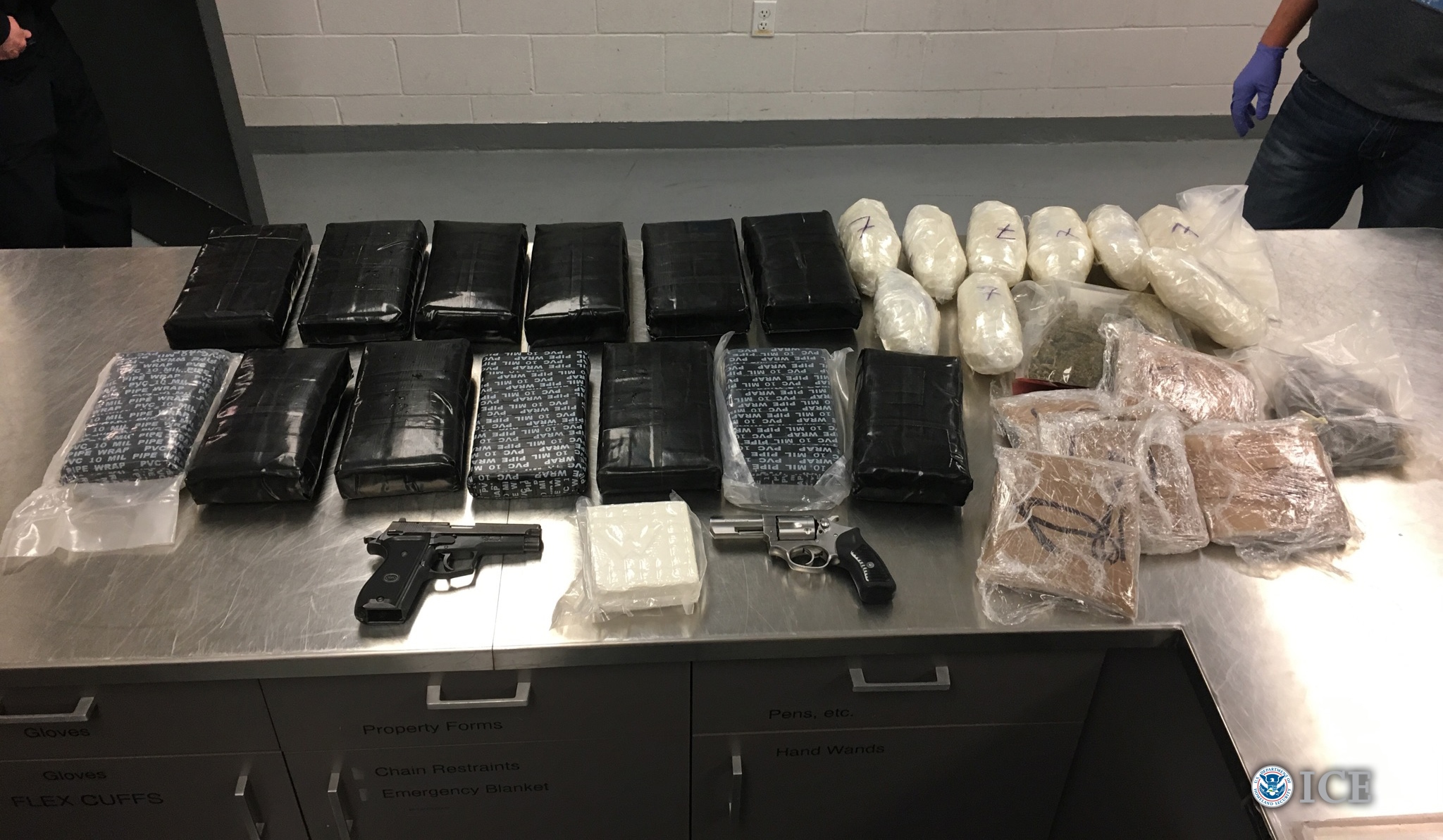 More than 46 pounds of heroin, cocaine and methamphetamine were seized in addition to two firearms.