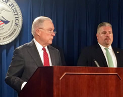 U.S. Attorney General Jeff Sessions applauds the work of HSI Boston’s Document and Benefit Fraud Task Force while Peter Fitzhugh, Special Agent In Charge, HSI Boston looks on; U.S. Attorney's Office, Boston, July 26