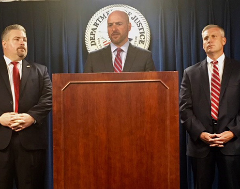 Left to right: Peter Fitzhugh, HSI special agent in charge, discusses the arrest as U.S. Attorney for Massachusetts Andrew E. Lelling and Harold H. Shaw, special agent in charge, FBI Boston Field Division, look on.