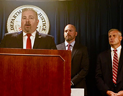 Peter Fitzhugh, HSI Boston special agent in charge (left) listens as U.S. Attorney for Massachusetts Andrew E. Lelling (center) announces indictment and arrest;    Harold H. Shaw, special agent in charge, FBI Boston Field Division is at right)