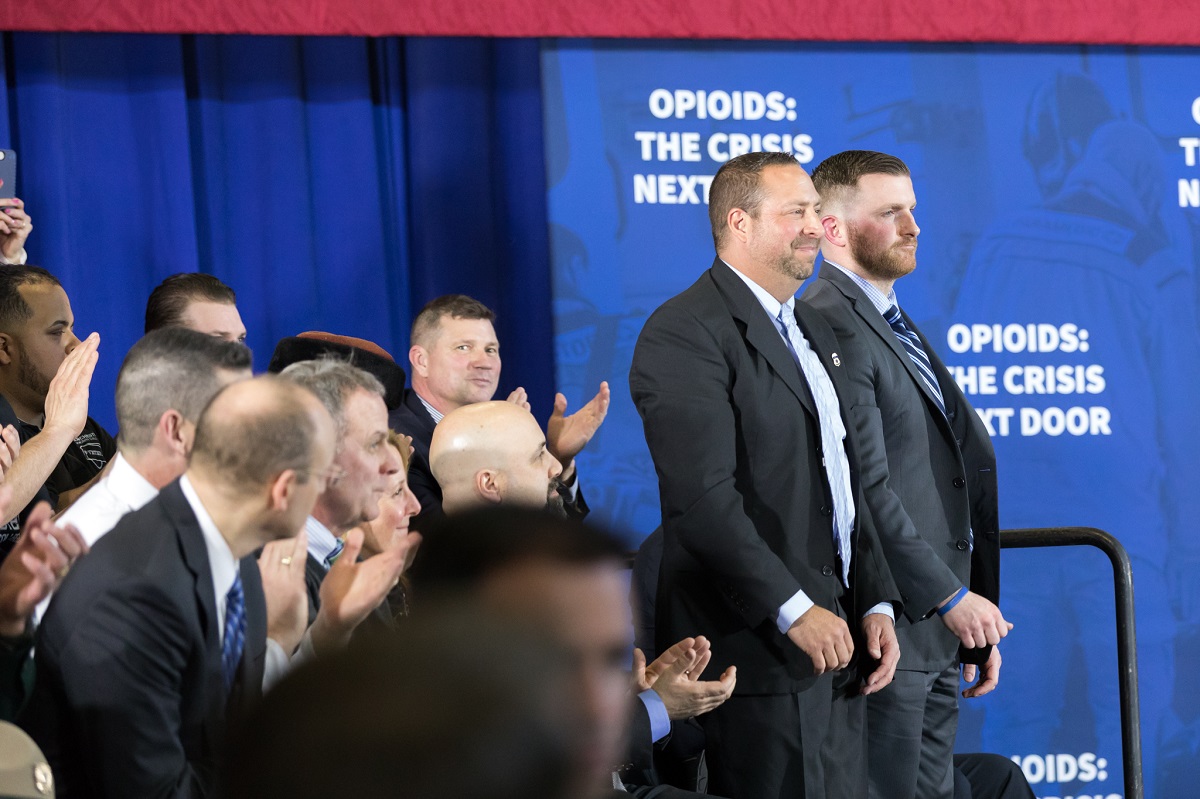 President Donald J. Trump recognizes law enforcement officers, HSI-Manchester Special Agent Ronald Morin (left) and Manchester, NH, Police Detective, and HSI Task Force Officer Patrick Maguire for their role in addressing the issue through Human Trafficking investigations, as President Trump deliver remarks on combating the opioid crisis at Manchester Community College, Monday, March 19, 2018, Manchester, NH. (Official White House Photo by Andrea Hanks)