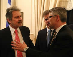Homeland Security Investigations (HSI) Special Agent David Keller of San Francisco (right) explains general details of this case to the Ambassador of Greece to the United StatesHaris Lalacos (Left). Keller worked with Antonios Sgouropoulos, San Francsico Consul General of Greece (Center), to finalize the details for the repatriation ceremony during the reception.