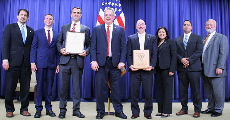 HSI personnel from Michigan and Ohio pose with James W. Carroll Jr., (center), the current director of the U.S. Office of National Drug Control Policy July 19, at the annual U.S. Interdiction Coordinator Award Ceremony.