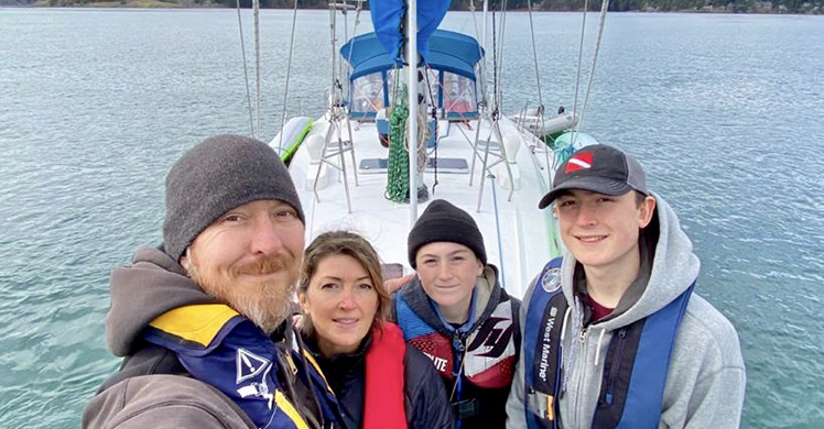 HSI Special Agent Steven M.,his wife Bobbi, sons Hunter, 17, and Chance, 13, pose for a family photo, March 23, before taking off on a family boating trip to the Strait of Juan de Fuca, where they later saved a man in danger of drowning. 