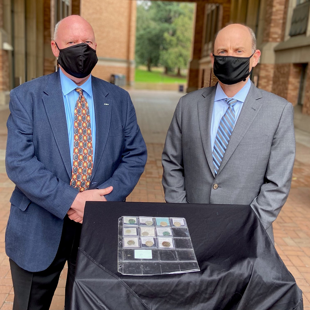 Brian Humphrey (left), Director of Field Ops for CBP in Seattle, and Special Agent in Charge Robert Hammer, who oversees HSI operations in the PNW, display some of the 51 Greek Hellenistic and early Islamic coins HSI transferred to the UW Libraries in a ceremony hosted on the UW campus, Feb. 18, 2021.