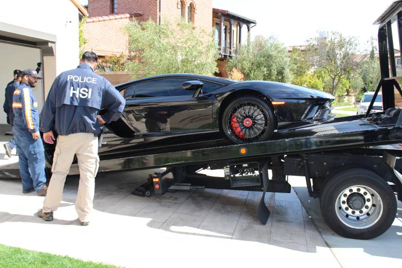 Special agents with HSI Los Angeles’s El Camino Real Financial Crimes Task Force seize Ferrari, Bentley and Lamborghini cars allegedly purchased with ill-gotten gains as well as more than $2 million in U.S. currency (2)