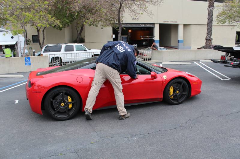 Special agents with HSI Los Angeles’s El Camino Real Financial Crimes Task Force seize Ferrari, Bentley and Lamborghini cars allegedly purchased with ill-gotten gains as well as more than $2 million in U.S. currency (3)
